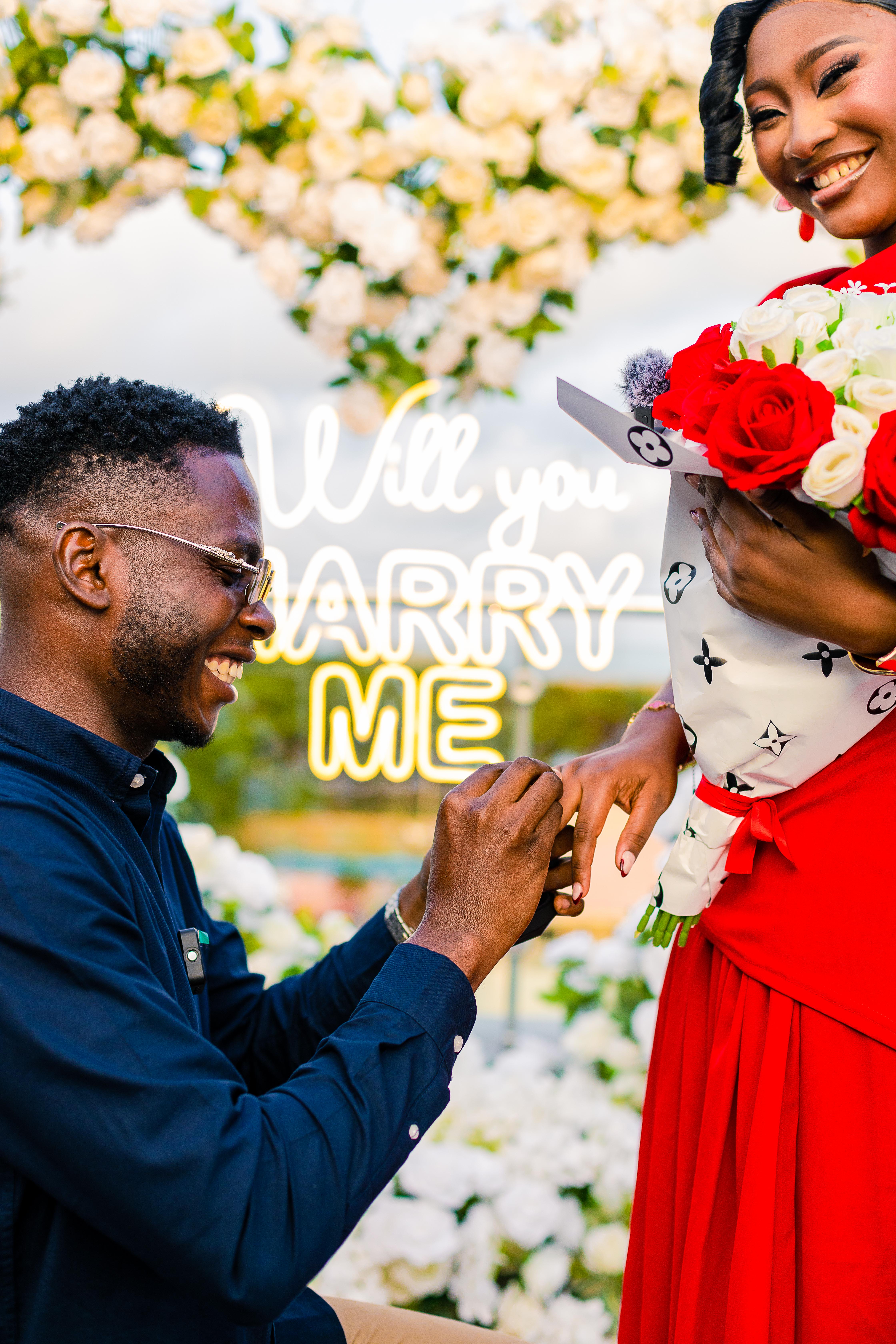 Emmanuel proposing to Precious at their rooftop engagement celebration
