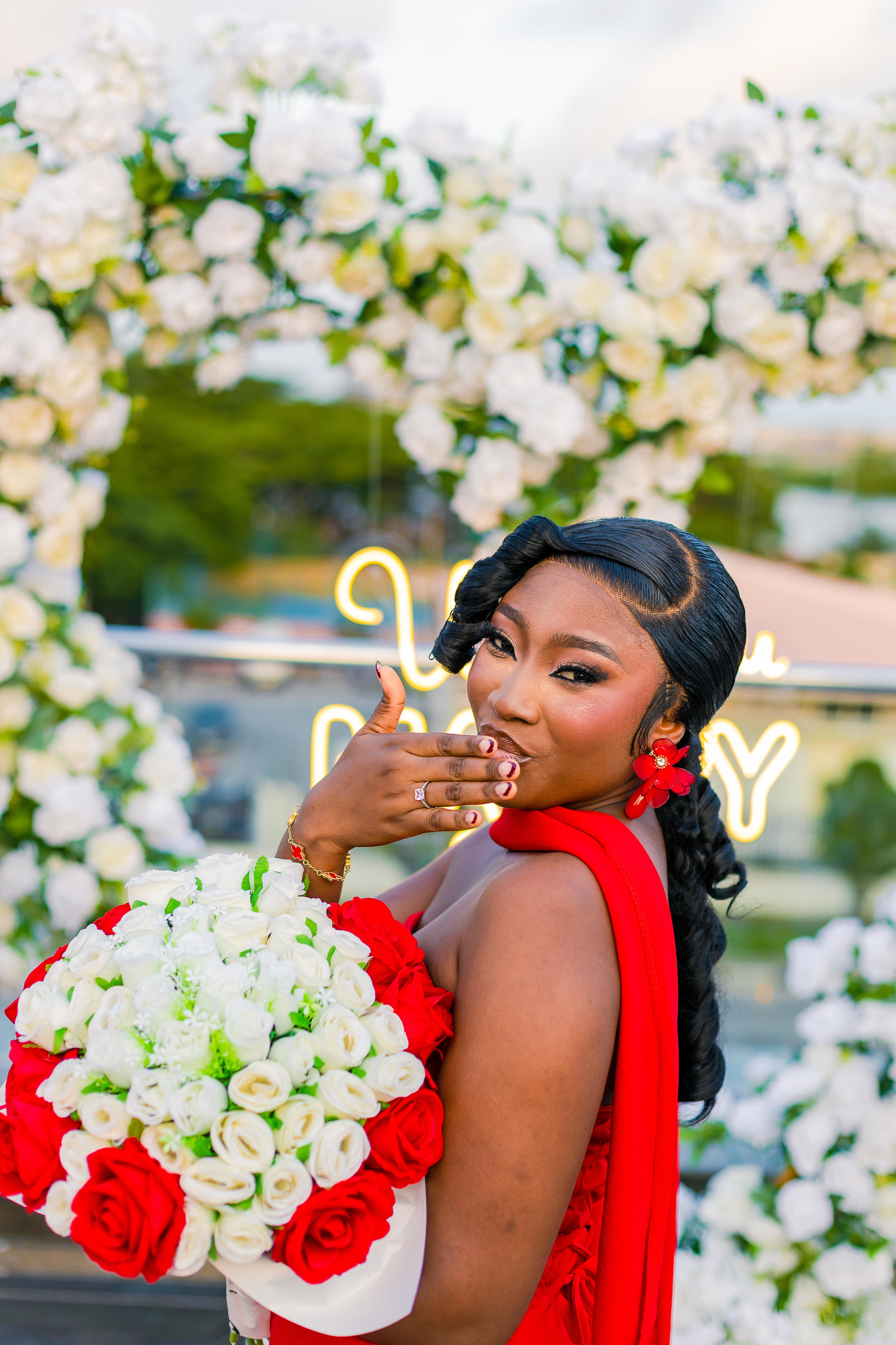 Precious smiling with her bouquet after the proposal