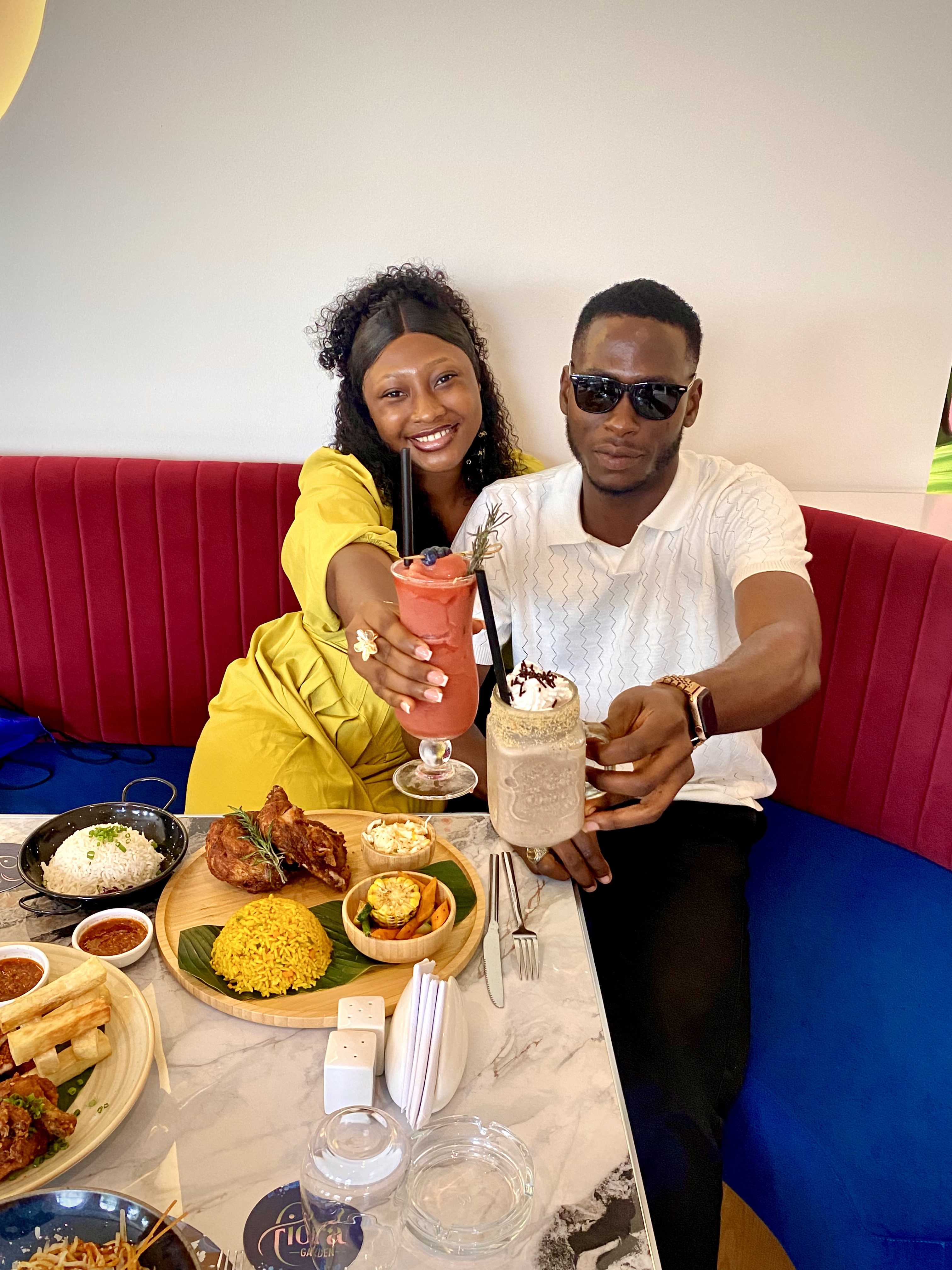 Precious and Emmanuel sharing drinks at dinner