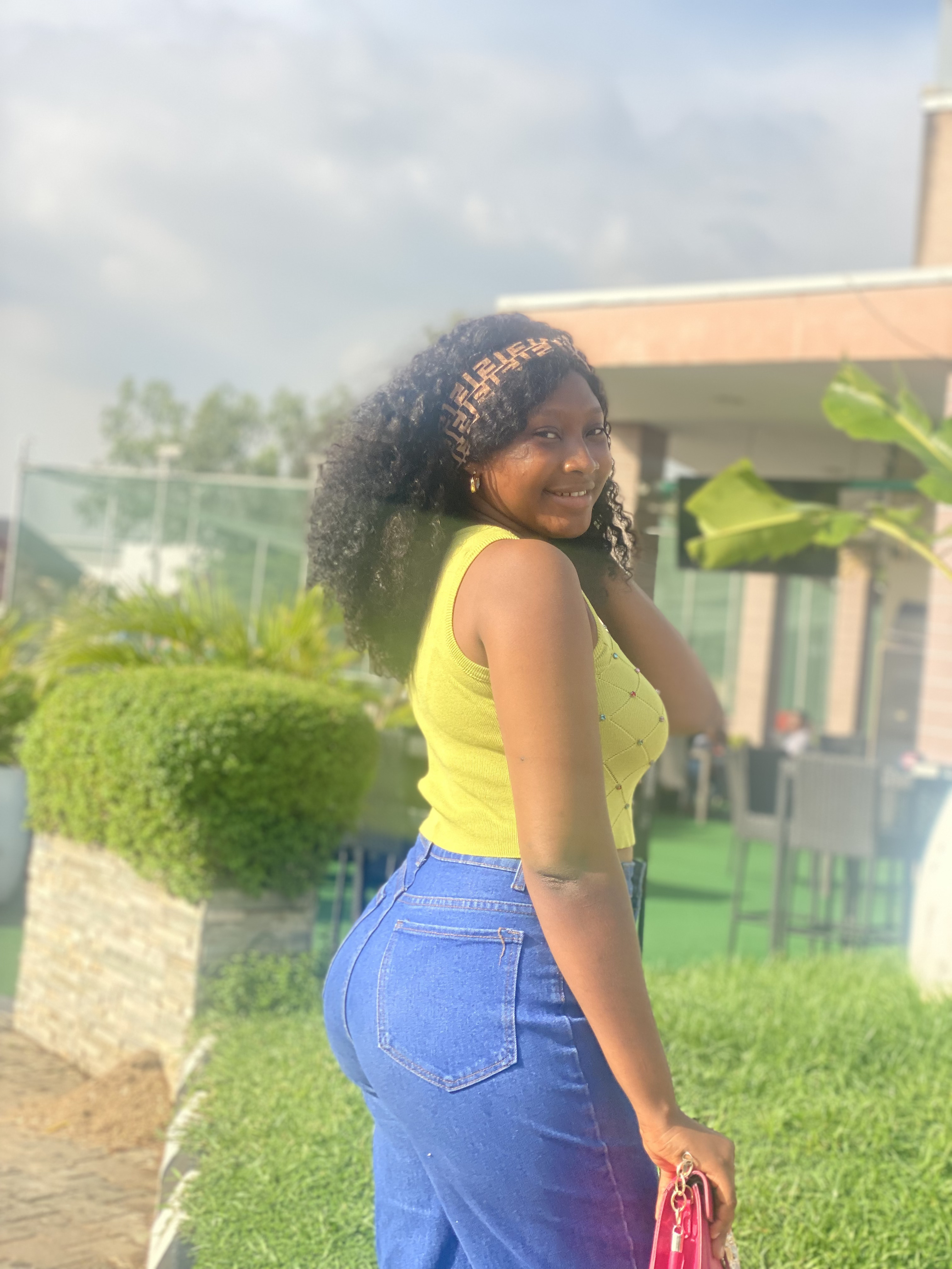 Precious smiling outdoors in a yellow top
