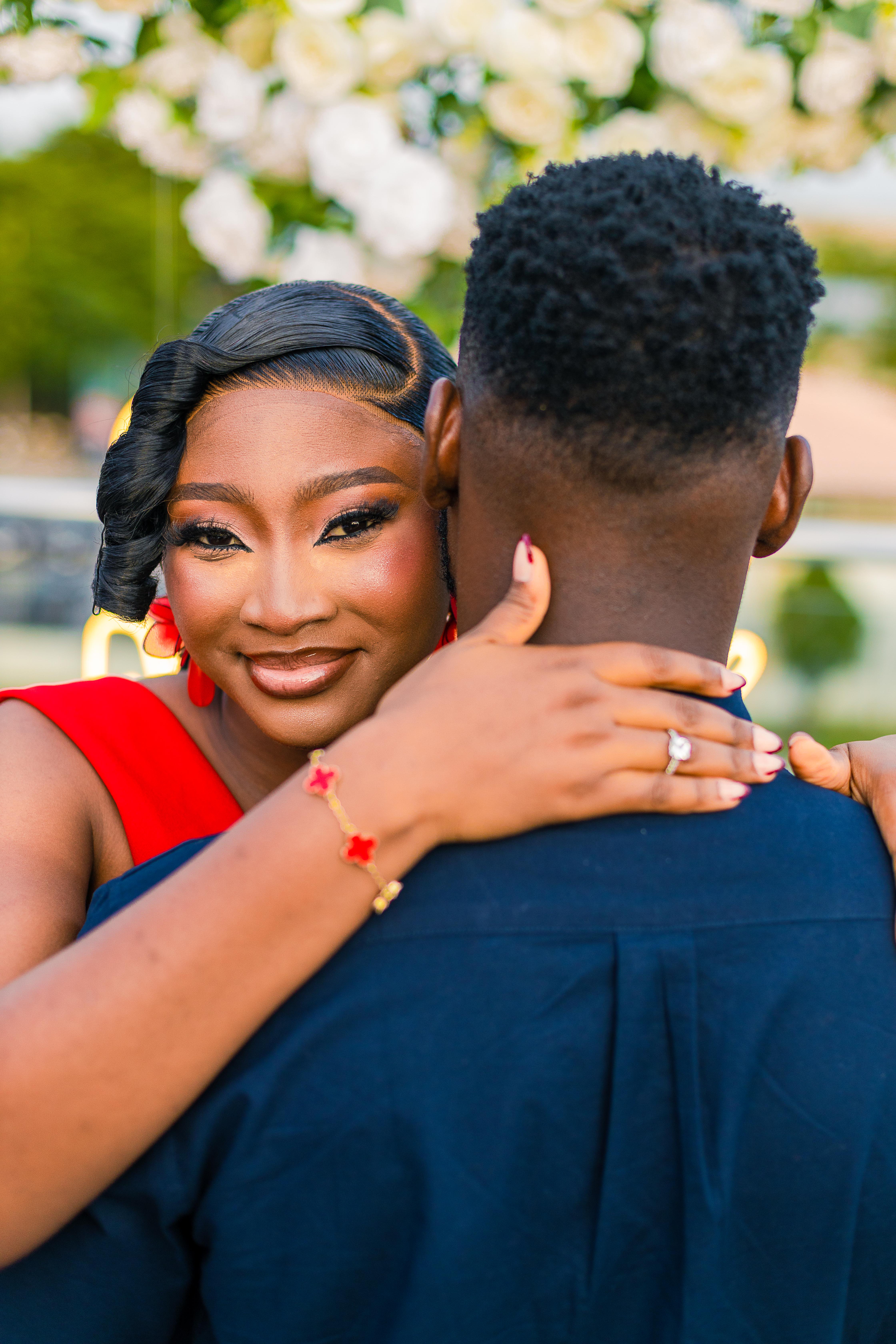 Precious embracing Emmanuel with her engagement ring visible